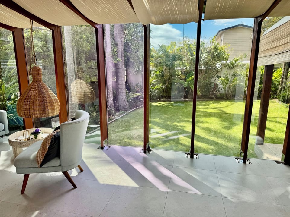 Curl up with a book & watch the garden come alive in the glasshouse reading room