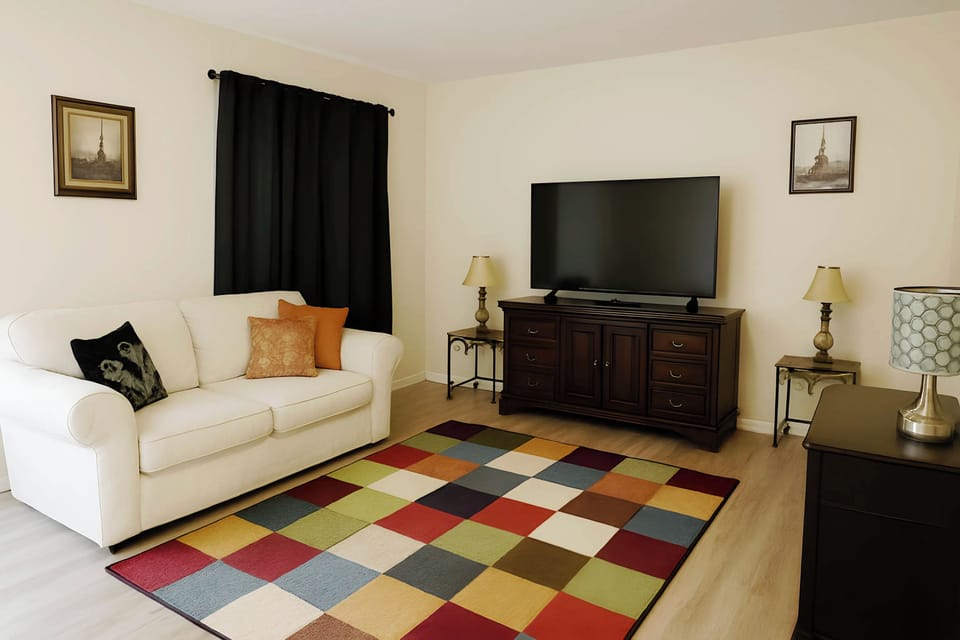 Large living room with five-seater sofas, workspace, and infotainment