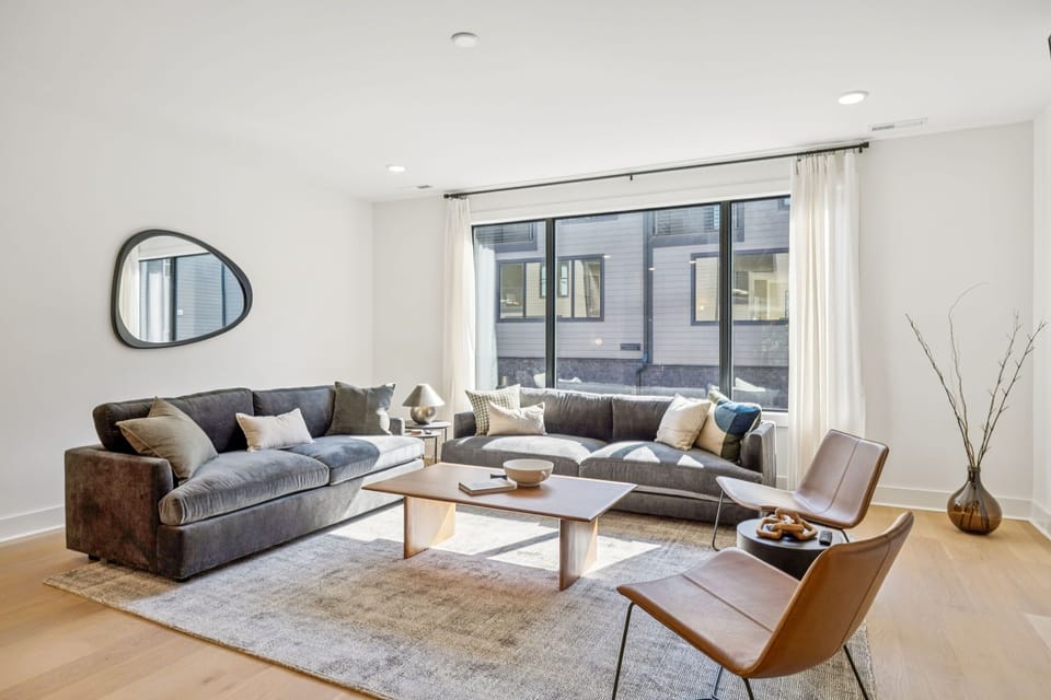 Living Room: Where modern design meets cozy comfort — unwind with friends and family in this elegant, sun-filled living room.