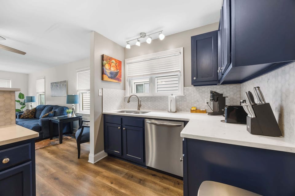 Kitchen: Cook and Connect – Enjoy this inviting kitchen with bold blue cabinetry, sleek finishes, and cozy seating that makes mealtime a delight.