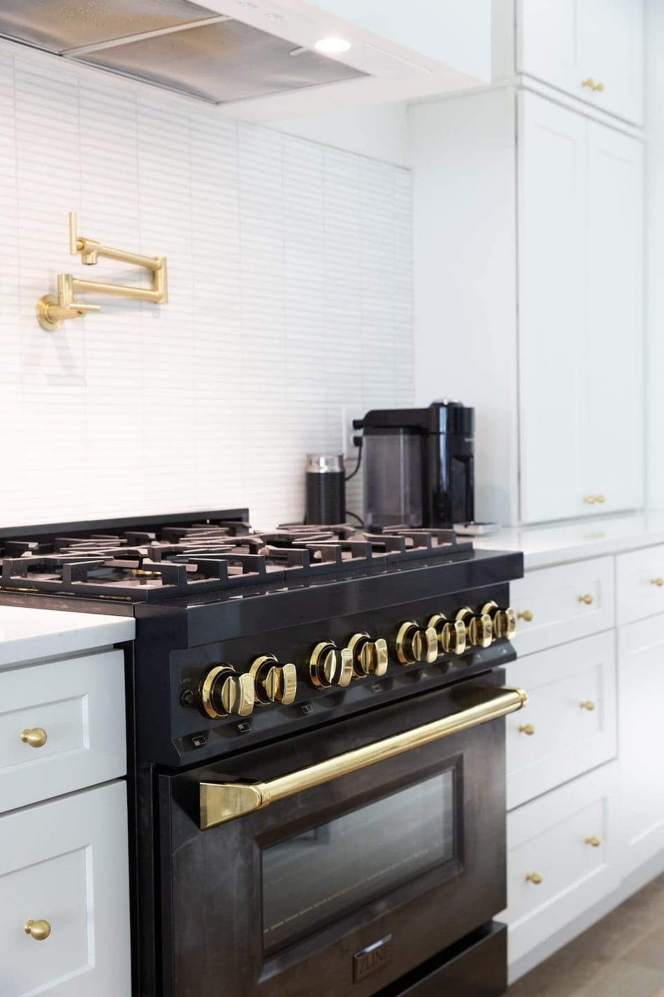  Whip up culinary delights on this sleek, modern range with stylish gold accents!