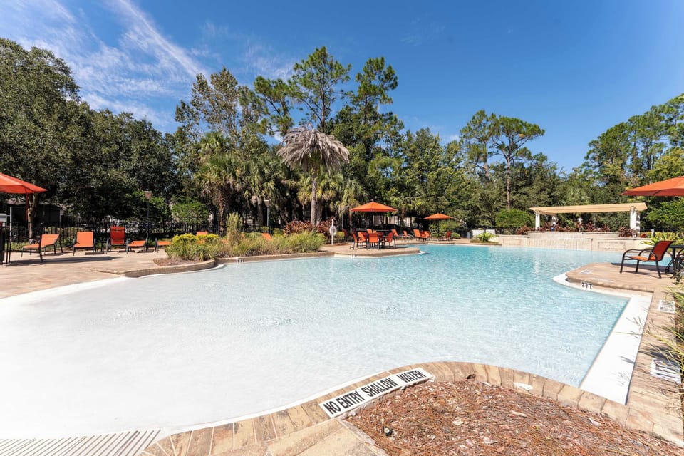 Dive into the refreshing resort pool, offering a vast oasis for swimming, sunbathing, and family fun under the Florida sun