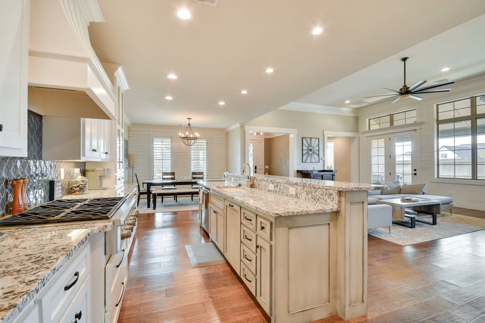 Chef’s kitchen with granite counters and ample storage space.