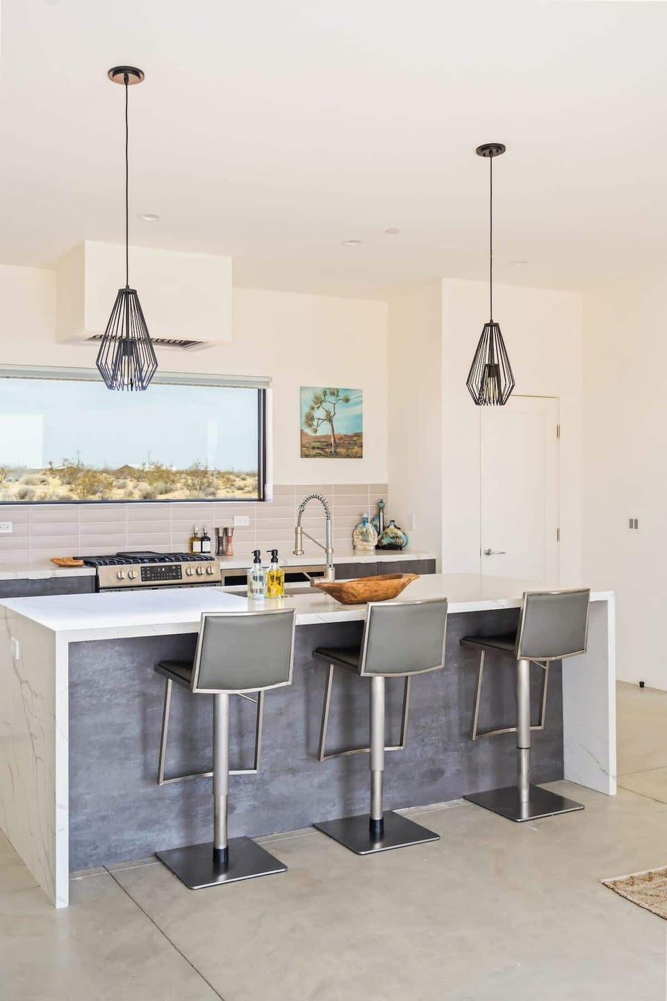The modern kitchen is fully stocked and makes preparing meals easy