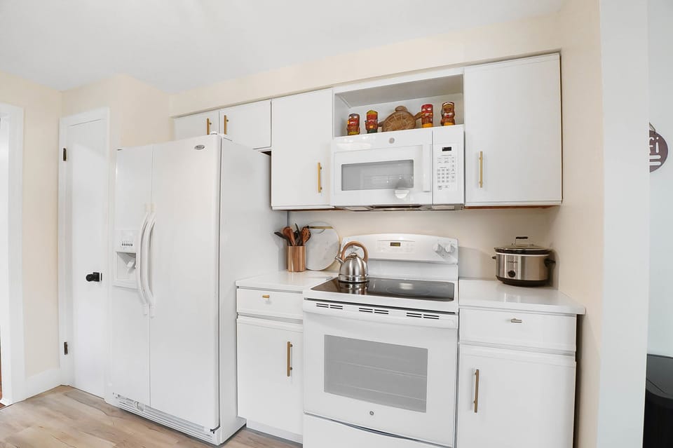 Kitchen includes crock pot, blender, mixer, and cookware. 