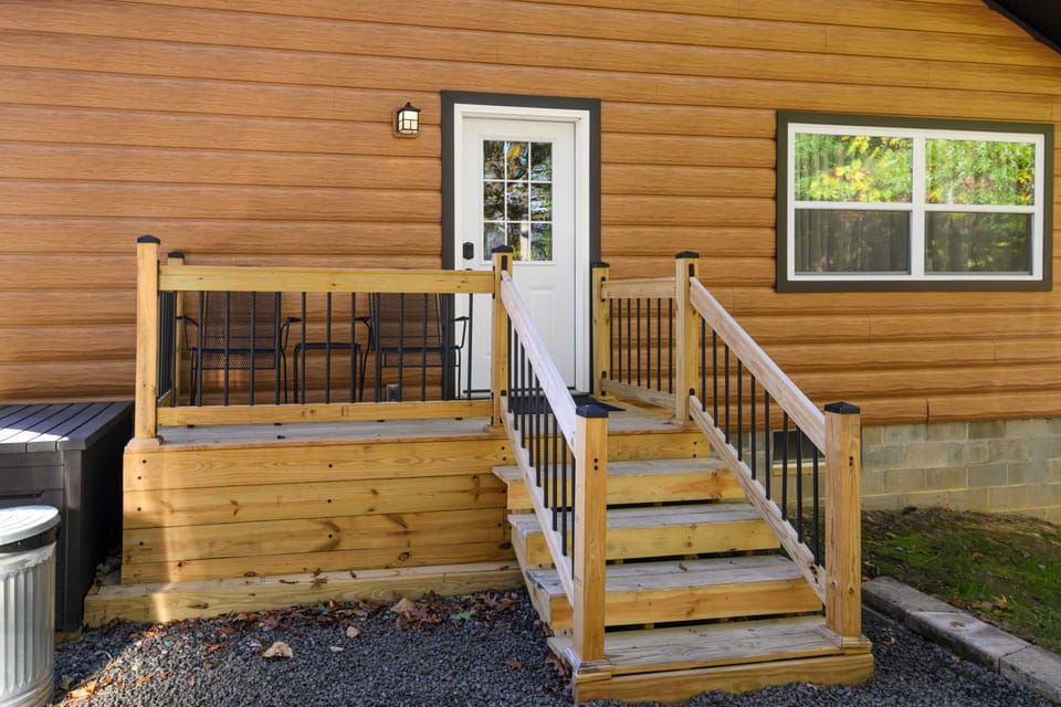 Rear entry with deck, outdoor activities, and grill left of deck