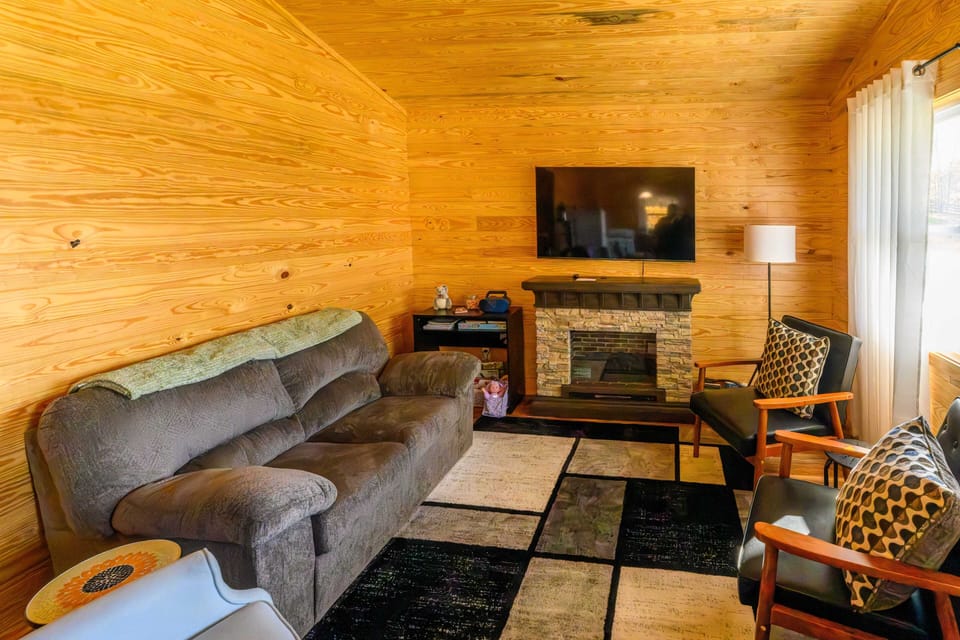 Living room with TV and a great view of the cabin's front yard and driveway.