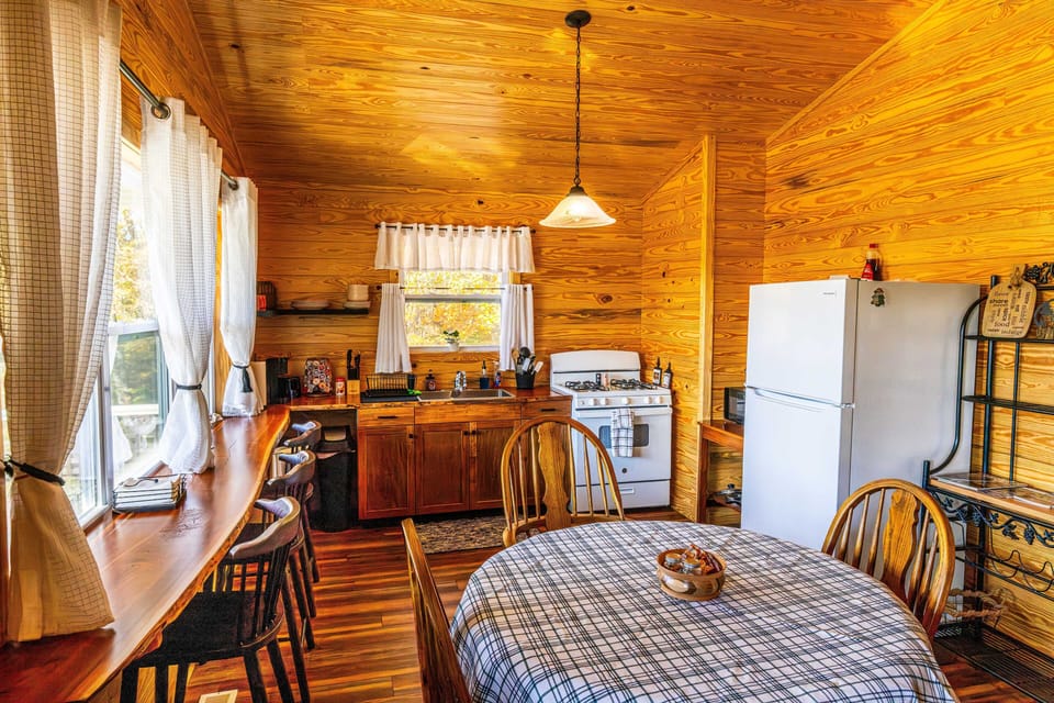 Fully equipped kitchen with large fridge, stove, double sink and lots of seating