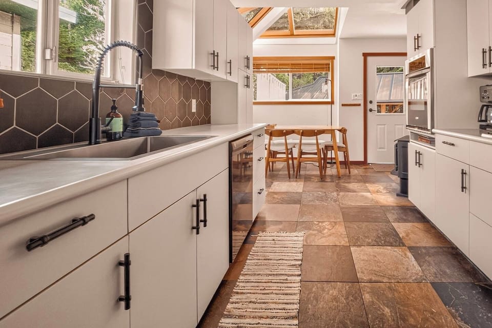 Bright, fully equipped kitchen with modern finishes and space to gather.