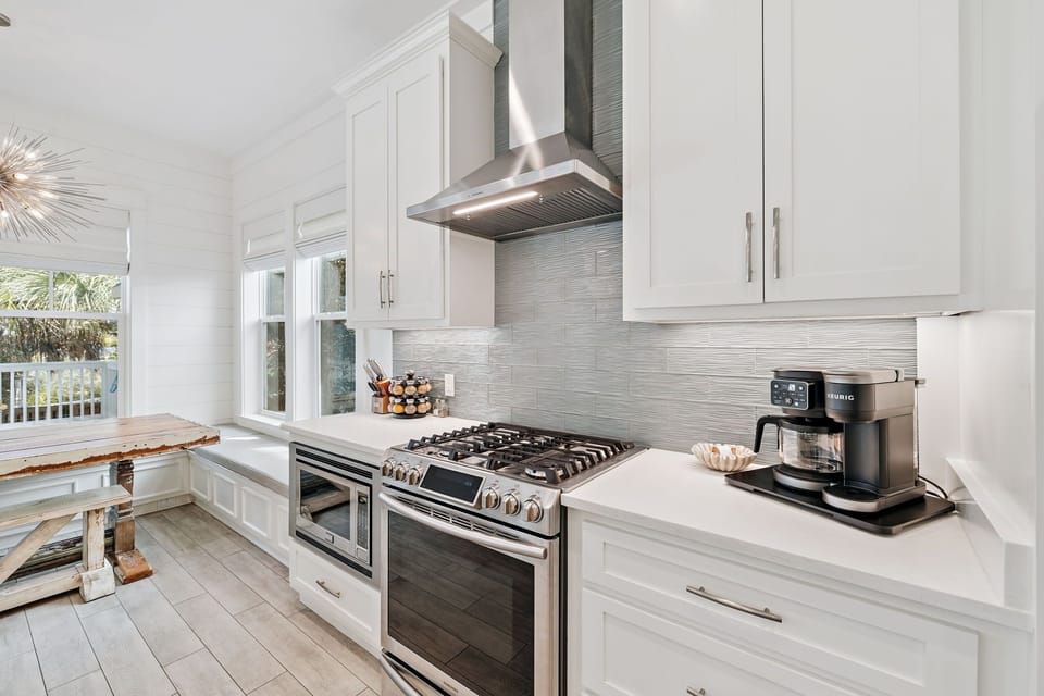 Beautiful kitchen featuring a large island, stainless steel appliances, ample seating, and fully stocked with all your essentials.