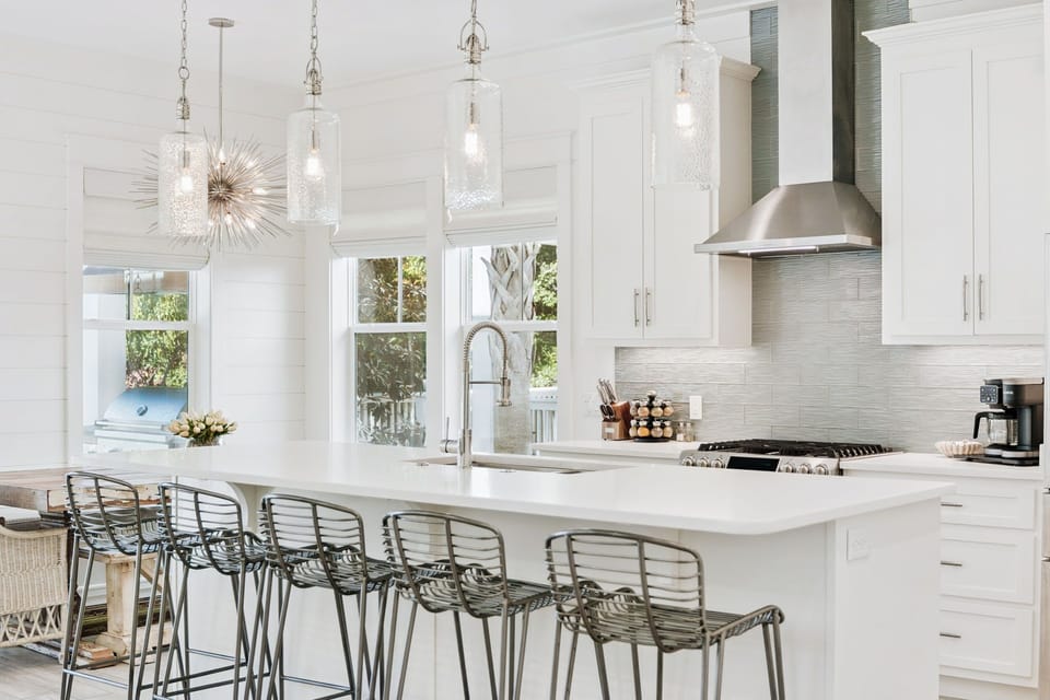 Beautiful kitchen featuring a large island, stainless steel appliances, ample seating, and fully stocked with all your essentials.