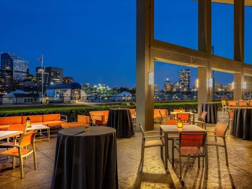 Sip evening cocktails at the outdoor bar with city lights.