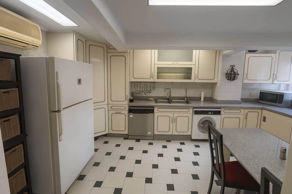 Well-equipped kitchen featuring generous cabinetry and a practical dining area—perfect for home cooking and convenience.