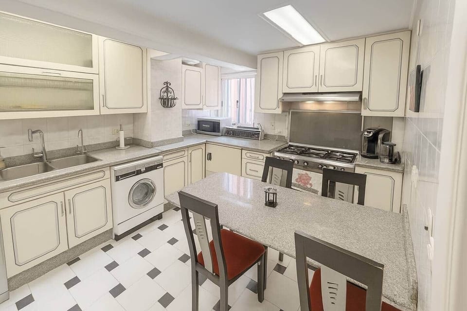 Bright and fully equipped kitchen with plenty of counter space and a cozy dining area for four.