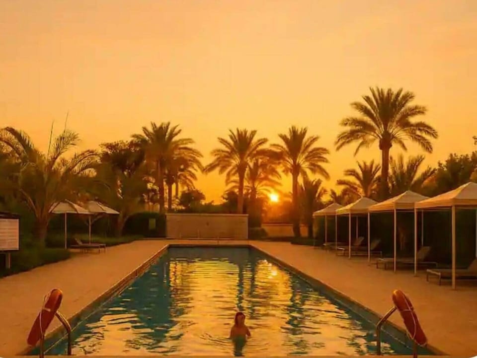 Imagine ending your day with a warm sunset glow, surrounded by palm trees and a tranquil pool just steps from your apartment. This is where modern comfort blends with a resort-like atmosphere, giving you the perfect base to experience Cairo in style.
