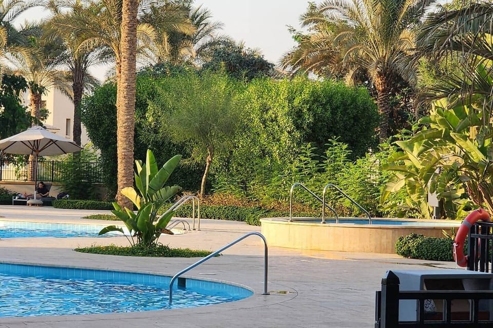 "Surrounded by lush greenery, this family-friendly pool area offers the perfect setting for a fun and refreshing day under the sun."