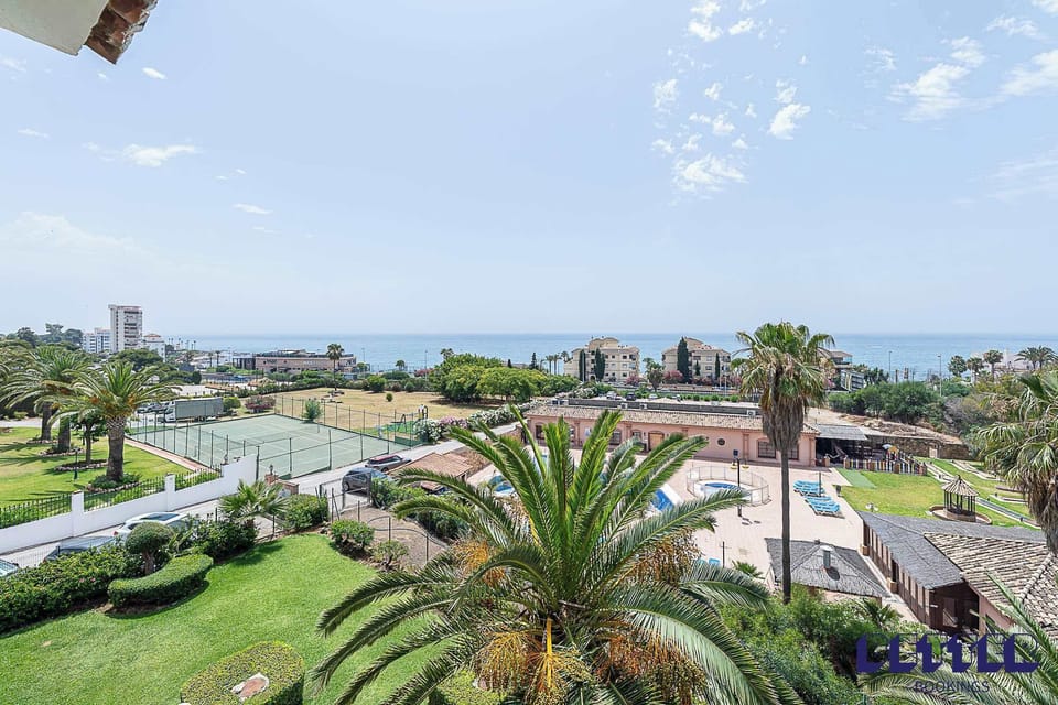 Wake up to breathtaking panoramic views overlooking the Mediterranean coastline. From your elevated vantage point, enjoy lush tropical gardens dotted with palm trees. The expansive view extends to the sparkling sea in the distance, creating the perfect backdrop for morning coffee or evening relaxation on your private terrace. Note that the pool and tennis courts shown on this image is not part of the community but the neighbouring area.