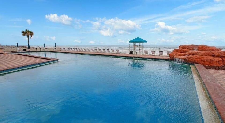 Enjoy sunny days by the refreshing outdoor pool.