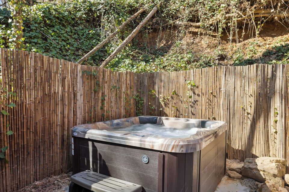 Soak in your private hot tub in the peaceful, wooded setting.  