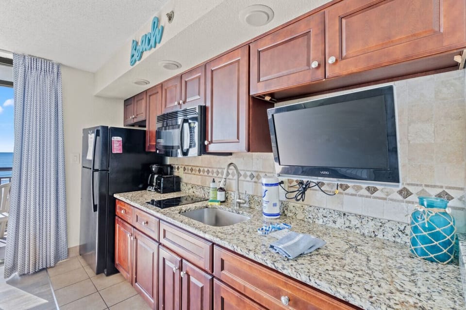 This beachfront kitchen is perfect for unwinding after a day in North Myrtle Beach. Features a Drip and Coffee Maker, Full-sized Refrigerator, Sing, 2-burner stovetop, toaster, Smart TV, dinnerware, cookware, and silverware for a great meal.