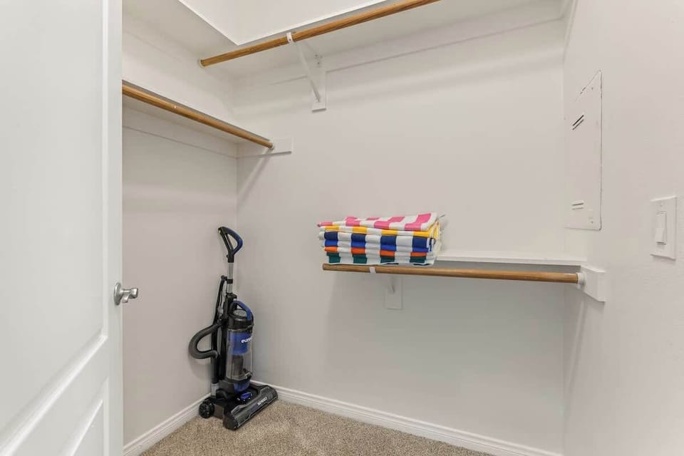 Expansive walk-in closet with shelving, storage, and essentials - perfect for extended stays and effortless organization.