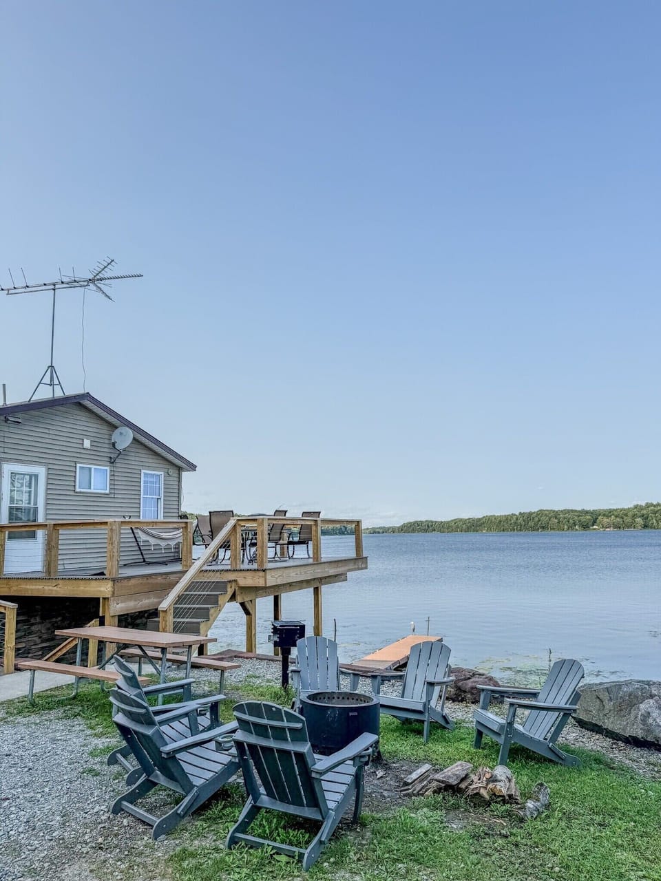 Waterfront cabin with lakefront deck, fire pit, and relaxing Adirondack chairs