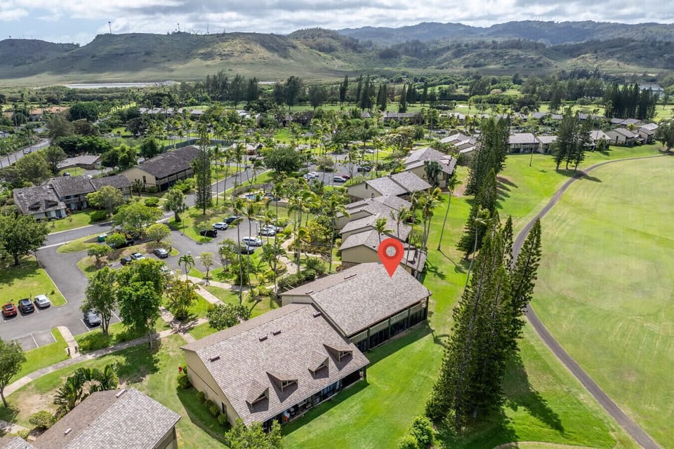 Peaceful aerial view of the community surrounded by rolling green.