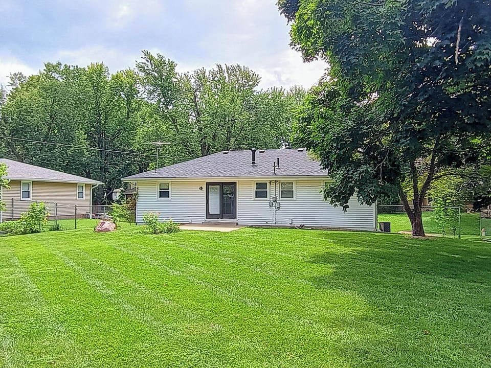 Large, fenced back yard with paved patio