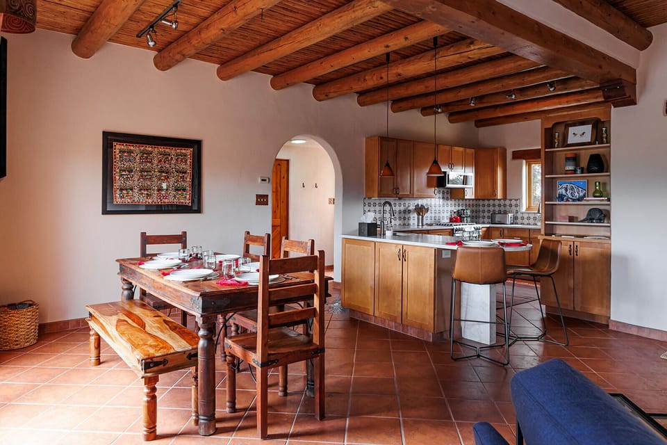 A spacious kitchen and dining space designed for family meals, laughter, and lingering conversations. Table comfortably seats 7. Island seats 2.