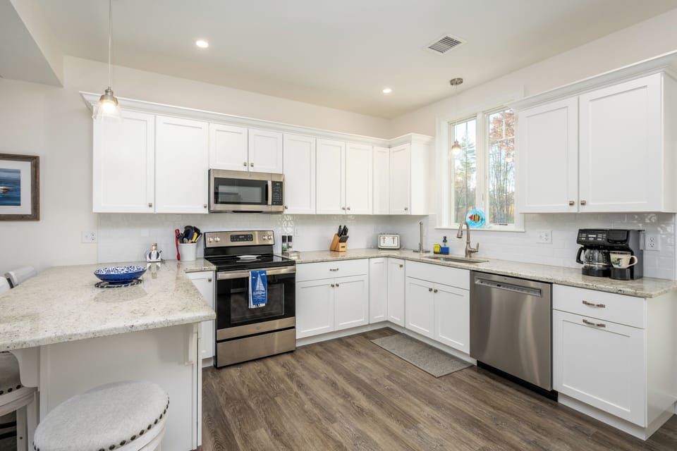 Fully equipped kitchen with stainless steel appliances.