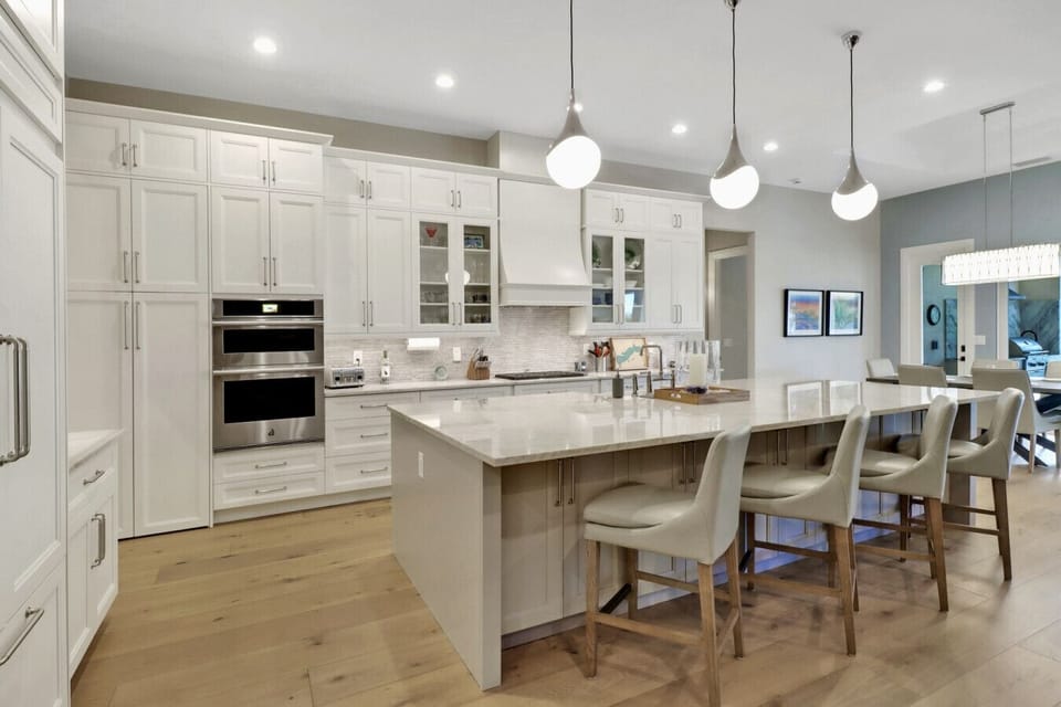 A cooks delight with a huge island and walk-in pantry