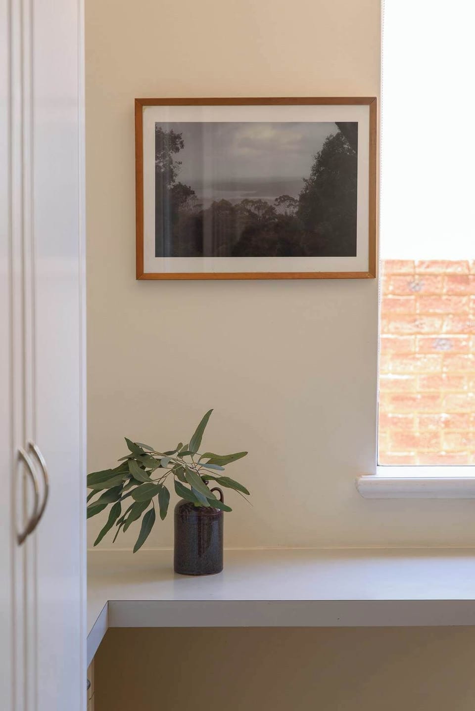 This sleek built-in desk offers a quiet corner for reflection or productivity. With soft natural light and a touch of greenery, it’s the perfect minimalist spot to start your day.