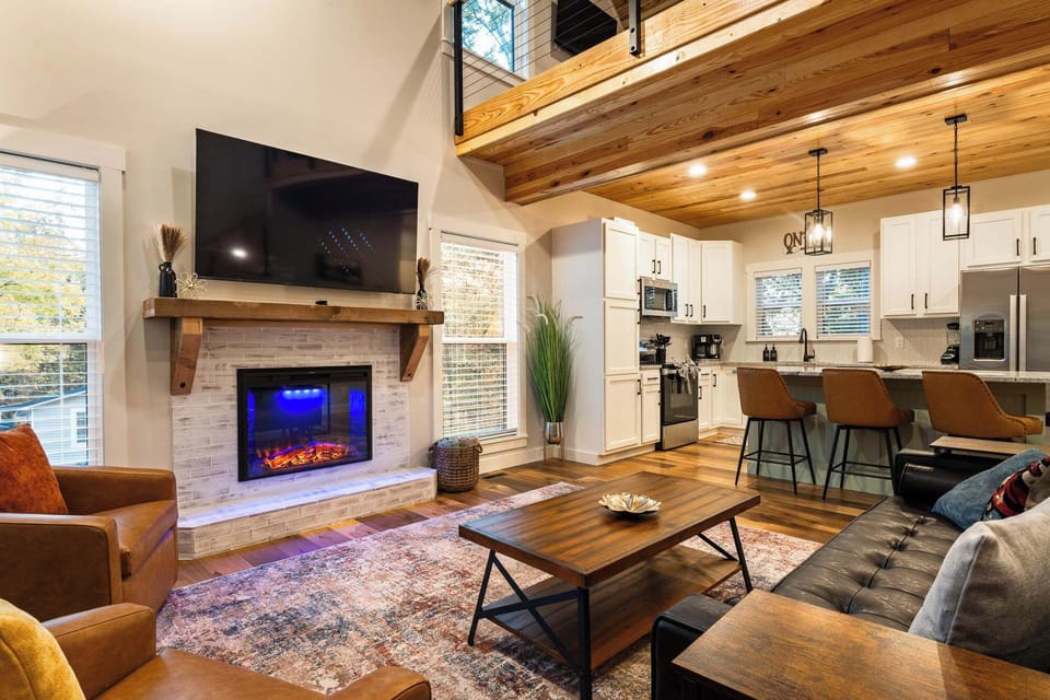 Cozy Living Room — vaulted ceilings, electric fireplace, and smart TV for movie nights.