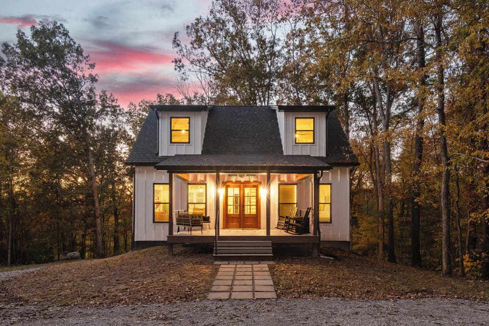 Twilight Welcome — arrive to warm glow and forest serenity at Nolin Hill House.