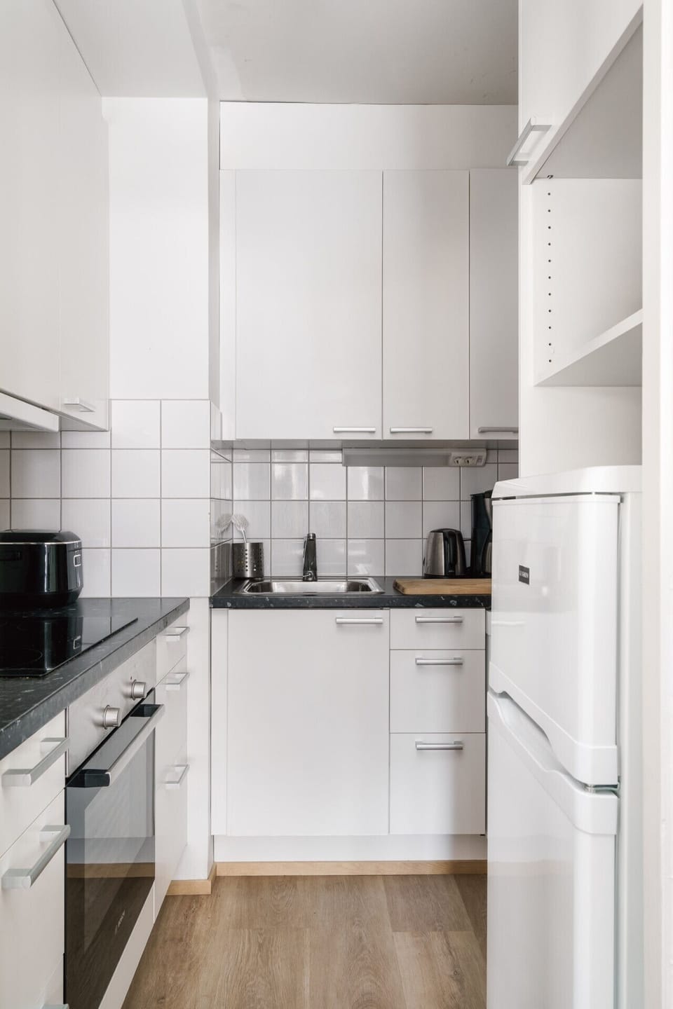 The compact kitchen is fully equipped with modern appliances, allowing you to prepare everything from quick snacks to full dinners.