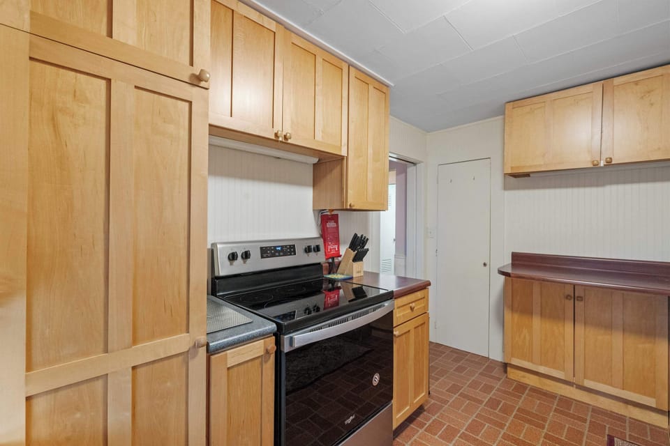 Modern appliances and classic wood cabinetry blend convenience with timeless charm.