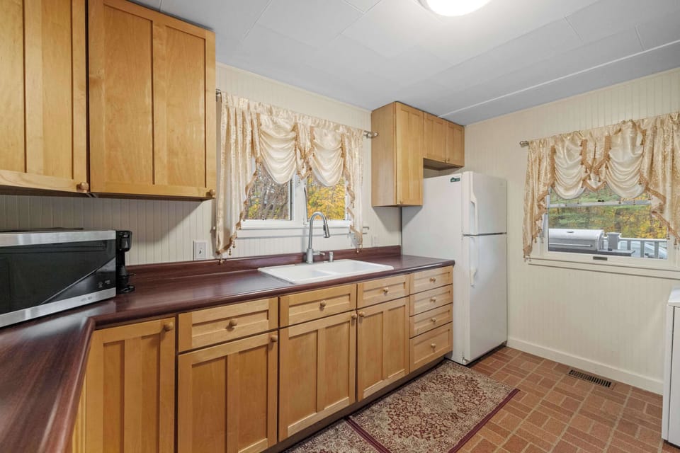 Fully equipped kitchen with full-size refrigerator, microwave, and everything you need for home-cooked meals.