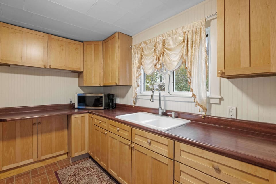 Bright and spacious kitchen featuring ample counter space, cookware, and dishware for your stay.