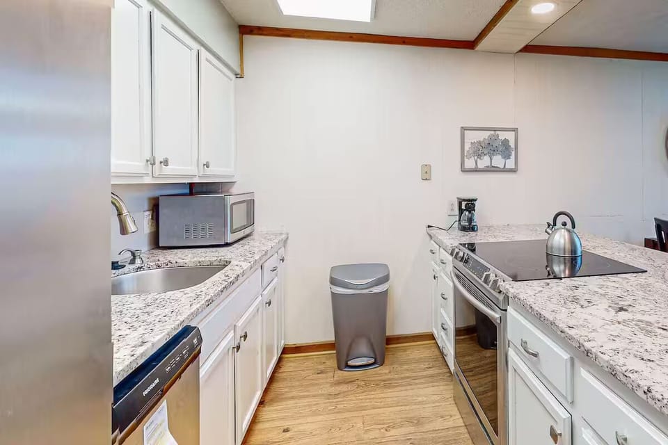 Sleek open kitchen seamlessly connected to the living and dining areas