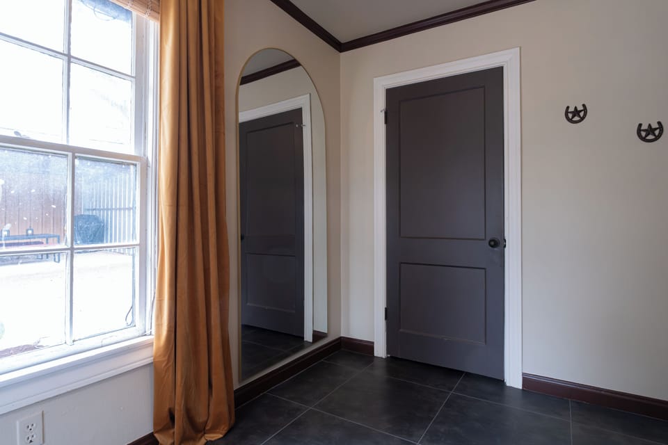 A thoughtfully designed space featuring a full-length mirror for easy outfit checks before heading out for the day. Functional touches like this make your stay feel effortless and considered.
