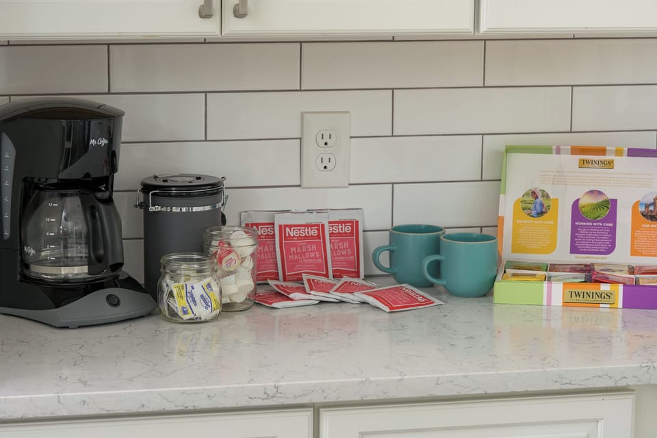 Welcome basket offering coffee, tea, hot chocolate, sugar, creamer and advil.