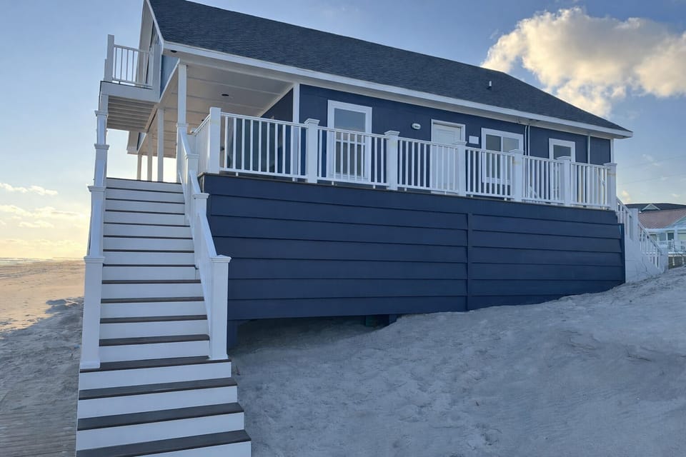 Left side of house stairs going to beach