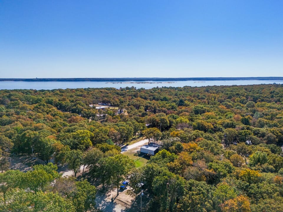 Aerial View | Serene Lakefront Surroundings | Peaceful Tree-Lined Neighborhood | Minutes from Waterfront Recreation