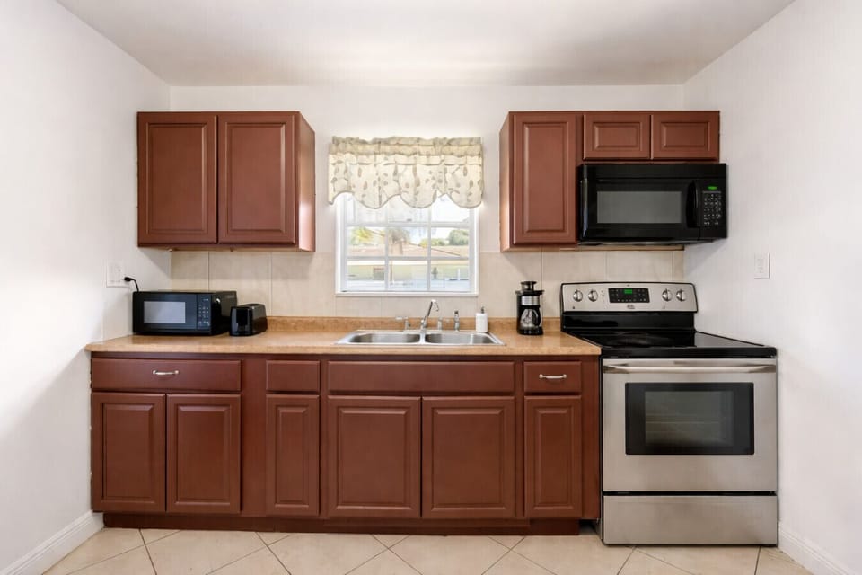 Ample fridge and cabinet space offer both practicality and organization in our inviting Florida kitchen