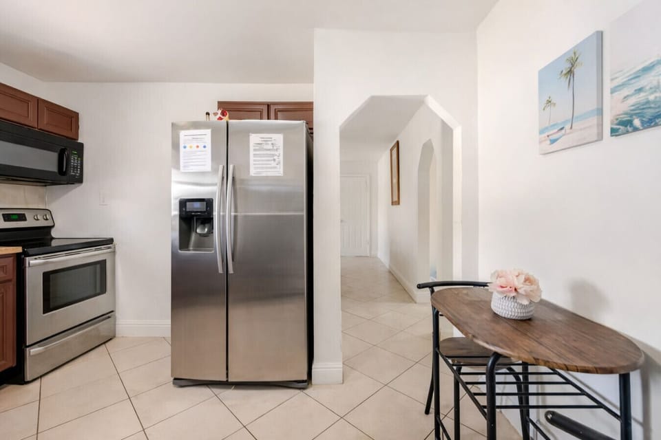 Ample fridge and cabinet space offer both practicality and organization in our inviting Florida kitchen