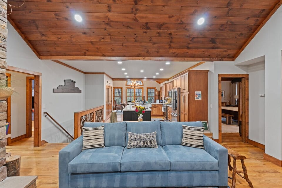 Living Room | Cozy Space with Stone Fireplace and Vaulted Wood Ceiling