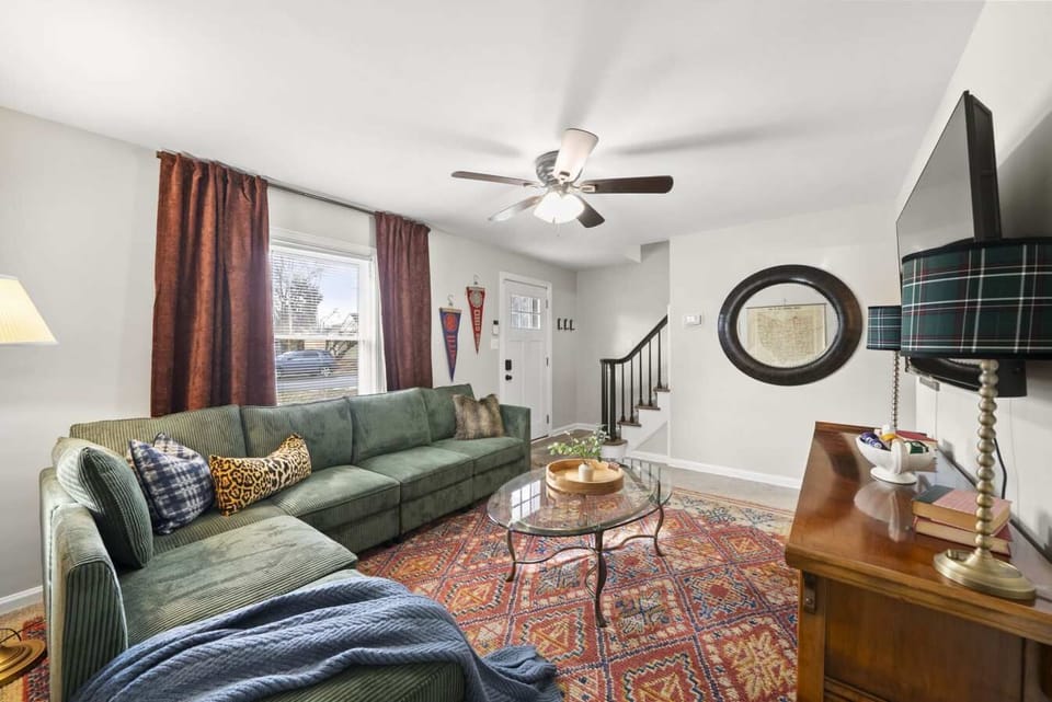 Cozy living room w/ plush sofa, layered rugs & warm decor that invites you to kick back & relax.