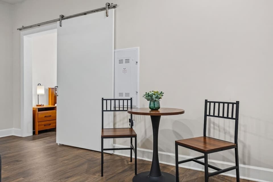- Cozy nook with table seating perfect for coffee, work, or quiet moments
- Simple space designed for comfort, light tasks, and easy morning routines
- Functional corner offering calm seating, natural light, and flexible use