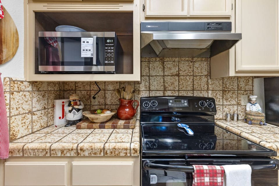 Kitchen | Electric Range & Microwave | Upper Cabinetry