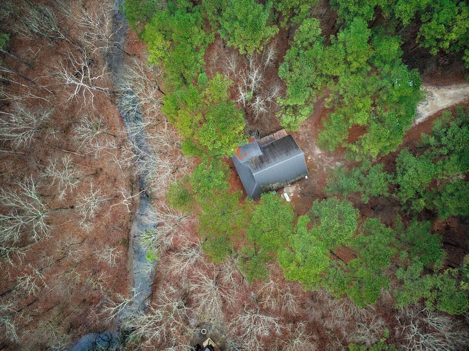 Cabin sits on a 1 acre lot with private creek access
